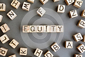 the word equity wooden cubes with burnt letters