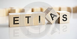 the word etias written on wooden cubes with assets icon on white background. asset management or financial accounting