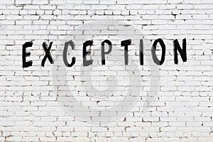 Word exception painted on white brick wall photo