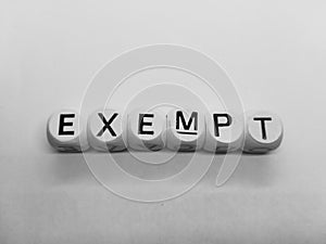 Word exempt spelled in dice photo