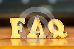 The word `faq` made of wooden letters