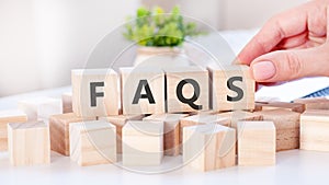 Word Faqs on the wooden blocks on table, business concept