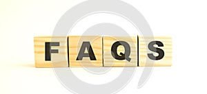 The word FAQS. Wooden cubes with letters isolated on white background