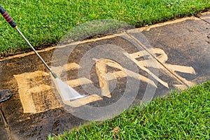 The word `FEAR` being erased with a pressure washer