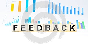 Word FEEDBACK made with wood building blocks