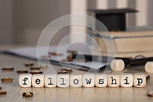 Word FELLOWSHIP composed of wooden dices