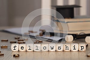 Word FELLOWSHIP composed of wooden dices photo