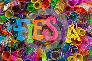 The word `fiesta` written in colorful letters with glitter and multicolored mash