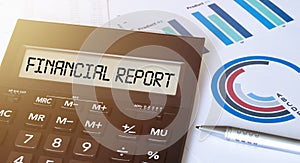 Word FINANCIAL REPORT on calculator. Business and finance concept