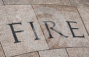 The word fire inscribed on stone blocks on the ground
