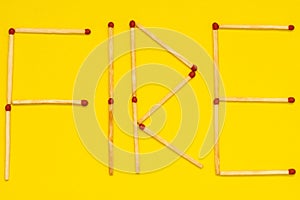 Word FIRE made with matches