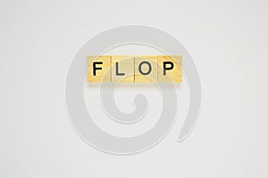 Word flop. Top view of wooden blocks with letters on white surface