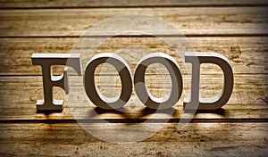 The word food on wooden table