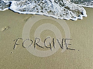 Word forgive in the sand