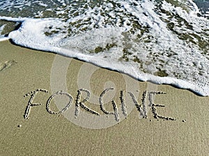 Word forgive in the sand