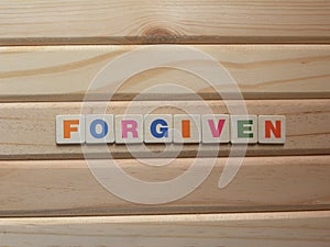 Word Forgiven on wood