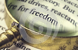 The word freedom read through a magnifying glass