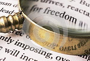 The word freedom read through a magnifying glass