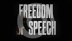 The word FREEDOM OF SPEECH burns and turns to ashes
