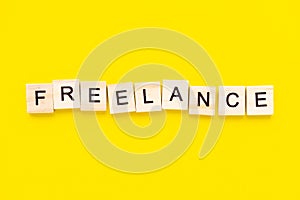 Word freelance. Wooden blocks with lettering on top of yellow background. Human Resource Management and Recruitment and