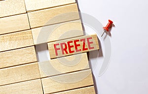 word Freeze on wooden block, business concept