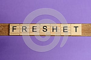 word freshet in small square wooden letters photo