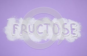 Word Fructose made of powder on violet background