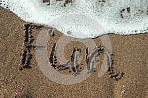 Word fun written in sand.