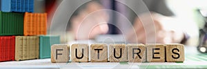 Word futures collected from cubes with cargo containers on office desk and business man in background.