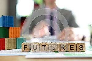 Word Futures made of wooden cubes near multi-colored blocks