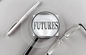 FUTURES text written on a sticky with pencil and glasses