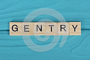 word gentry made of small gray wooden letters