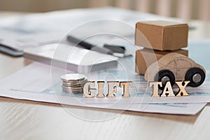 Word GIFT TAX composed of wooden letters. photo