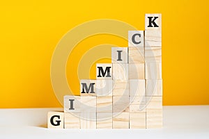 the word gimmick is written on a wooden cubes, concept