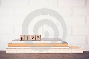 The word GIVE, letters and copy space background, vintage