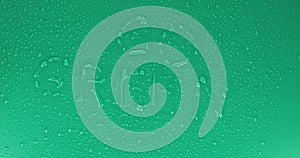 The word Go Green written in drops on a green background. Rotation. World inscription