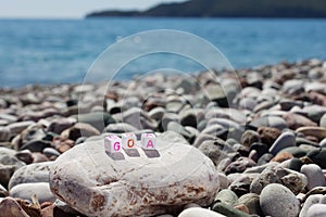 The word Goa on the pebbles