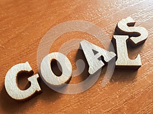 The word `goals` made of wooden letters