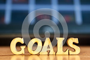 The word `goals` made of wooden letters