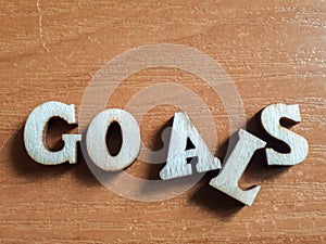 The word `goals` made of wooden letters