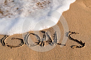 Word goals in the sand of a beach