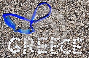 The word Greece made of shells on beach in the sand.