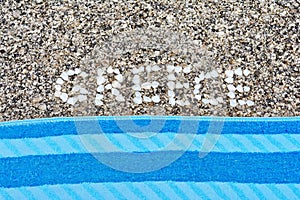 The word Greece made of shells on beach in the sand.