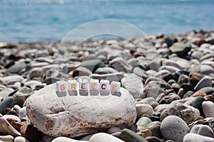 The word Greece on the pebbles