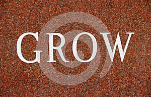Word Grow on Red Granite background