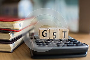 Word of GST spelled with colorful wooden alphabet blocks.Selective focus,shallow depth of field