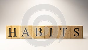 The word Habits was created from wooden cubes. education and work.