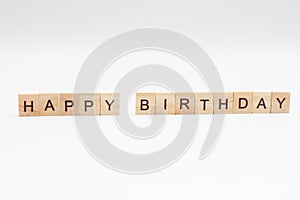 Word HAPPY BIRTHDAY made of wooden blocks on white background