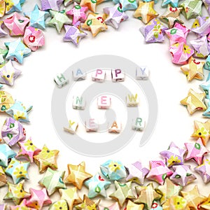 Word happy new year with origami lucky stars