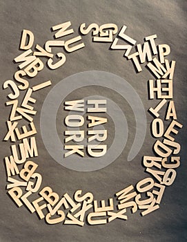 Word Hard Work In Wooden Cube Alphabet Letters Top View On A rustic paper Background